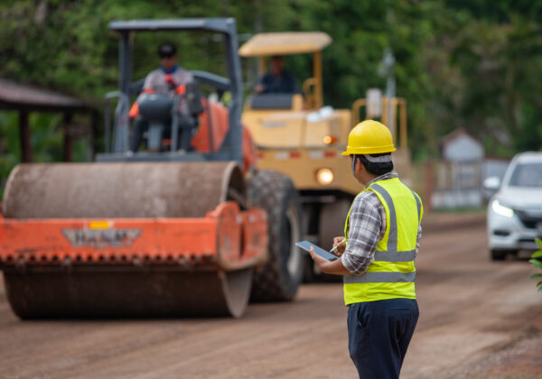 Engineer supervising the construction of asphalt roads